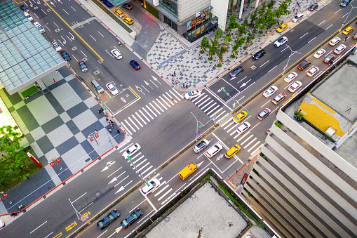 An aerial view of traffic and pedestrians on busy daytime streets in central Taipei, Taiwan.