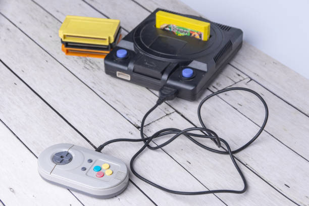 istock Old console and cassettes on the white background. Wooden white table 1190857038