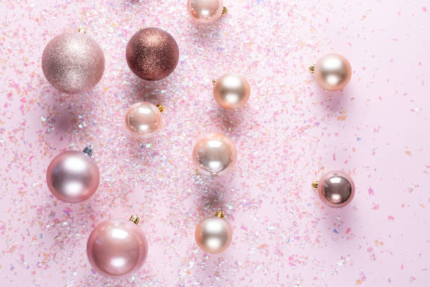 istock Christmas tree balls on pink background with shiny glitter 1190857145