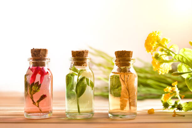 istock Three jars with plant essence on wooden table background front 1190860075