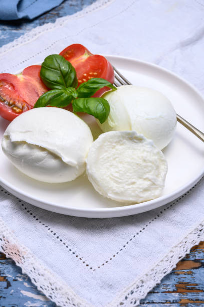 istock Cheese collection, organic mozzarella soft cheese served with ripe tomato and fresh green basil 1190860917