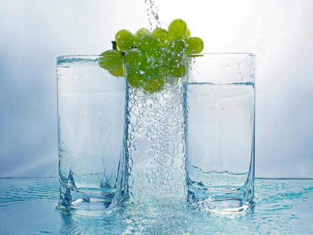 istock Grapes with two glasses and pouring water making bubbles 1190862170