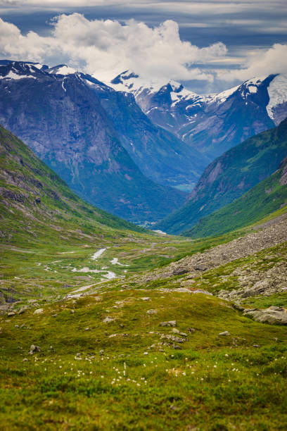 Mountains landscape peaks covered with snow and green valley. View from national tourist scenic route Gamle Strynefjellsvegen, from Grotli to Videseter, Norway