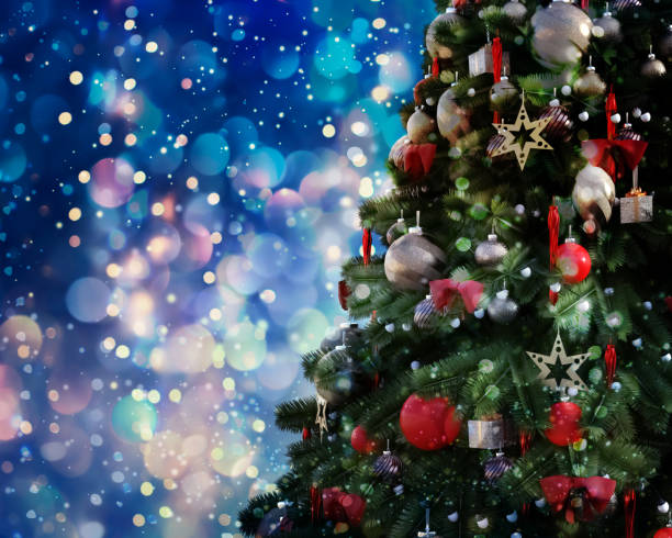 istock Christmas tree against a glittery luminous background 1190863019