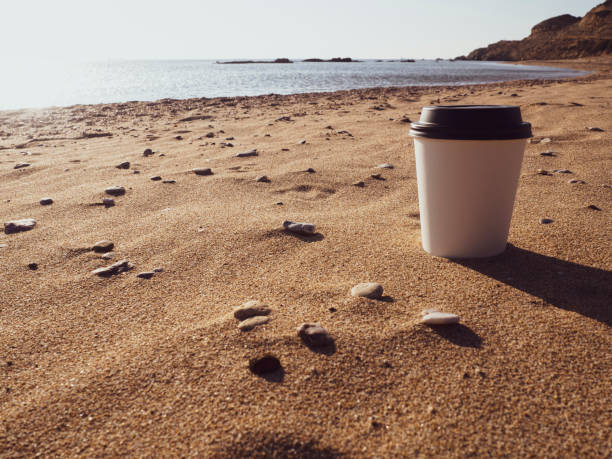 Cup of coffee on the beach