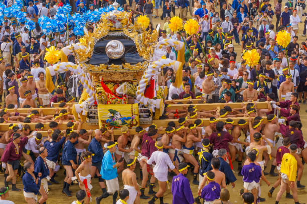 Nada no Kenka Festival, in Himeji Himeji, Japan - October 14, 2019: Portable shrine carried by men in traditional dressing, and crowd. Part of the Nada no Kenka Festival, in Himeji, Japan nada no kenka matsuri stock pictures, royalty-free photos & images