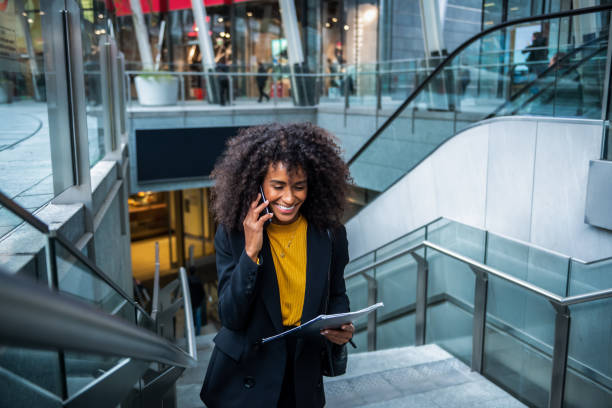 istock Businesswoman on escalator 1190866178