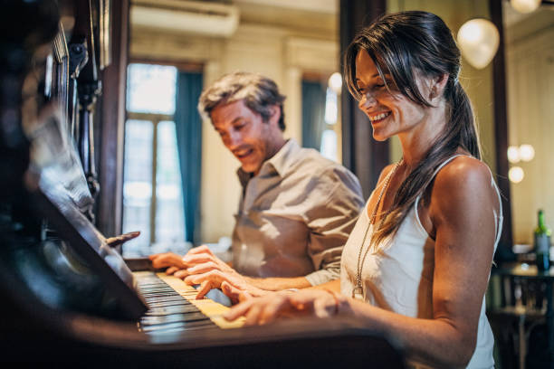 istock Couple playing piano together 1190866758