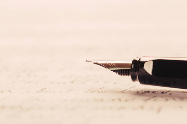 istock fountain pen on paper with ink text closeup 1190866860