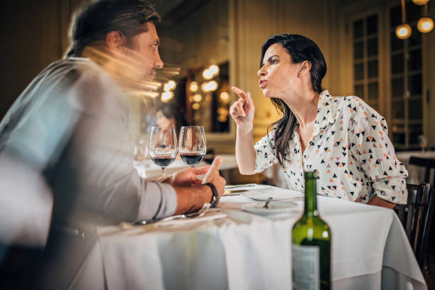 Mature couple arguing in restaurant