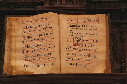 Murcia, Spain- November 16, 2019: Vintage book with antique scores of liturgical songs in the cathedral of Murcia in Spain