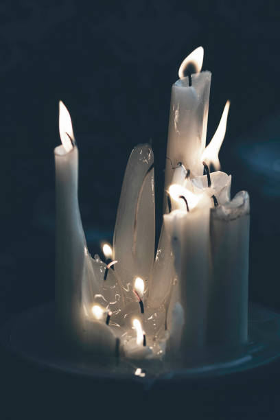 istock Set of white candles lit.  Twinkling candle light, dark background 1190877291