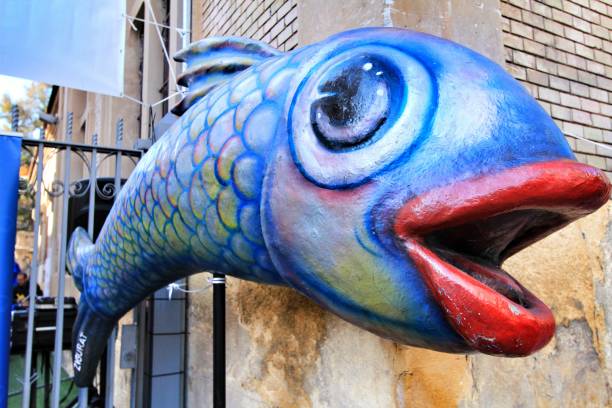 Murcia, Spain- November 16, 2019: Stone cardboard figures characterized for the sardine burial parade, a festivity of Murcia province in Spain.