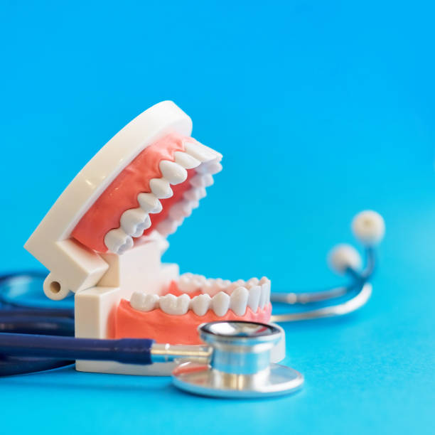 istock White teeth model and stakescope on blue background. teeth care. concept of preventive examination of the oral cavity. 1190879685