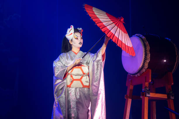 istock Traditional Japanese performance. Actress in white with umbrella dancing. 1190882861