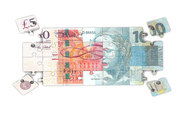istock Pound and Reais Jigsaw Pieces 1190883590