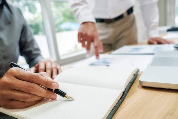 istock Business team brainstorming and discussing with financial data and report graph. Teamwork meeting working concept. 1190886465