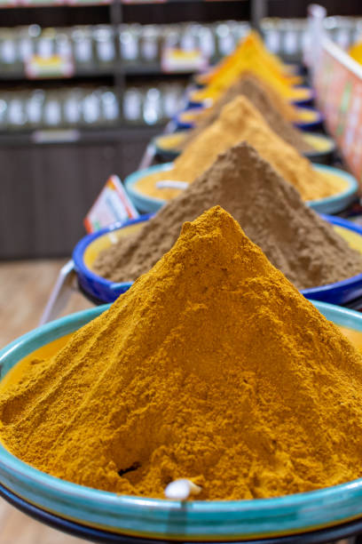 Dried kitchen herbs and different spices in boxes for sale in shop