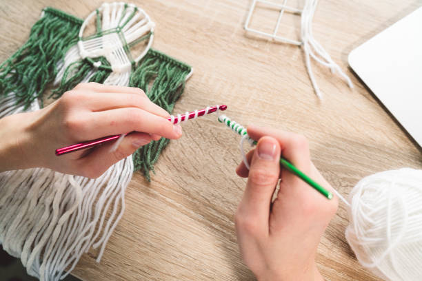 istock Woman hands holding crochet needles, learning a new skill 1190886884