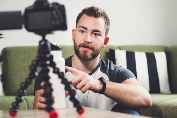 istock Young man, a vlogger with a filming set up 1190886887