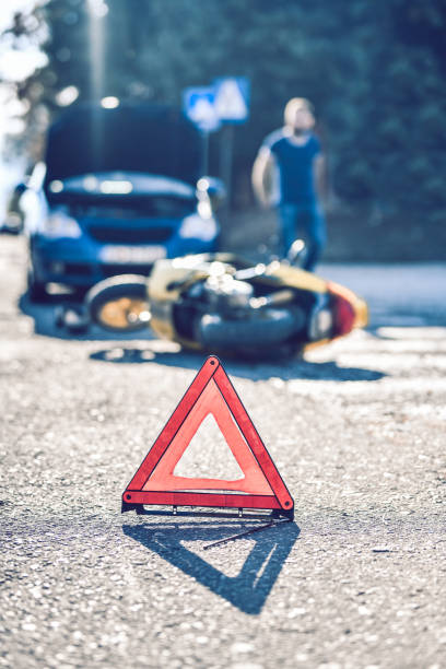 istock Warning Triangle On A Car And Motorcycle Accident Scene 1190889098