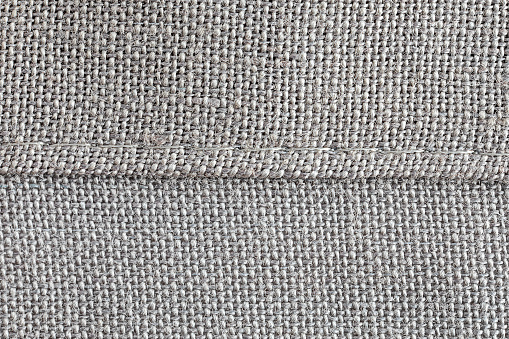 extreme close up of a hem of woven cotton fabric
