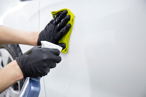 Cleaning the car body from bitumen with special liquids.