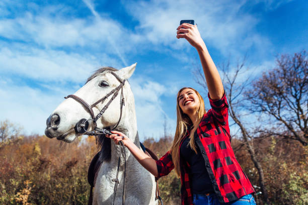 istock Woman with white horse 1190892865