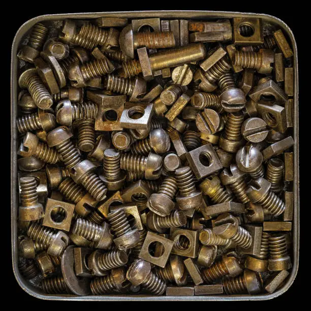Photo of Tin with rusty old bolts and nuts