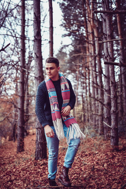 istock Handsome Male With Ornamented Shawl Walking Through Autumn Forest 1190894300