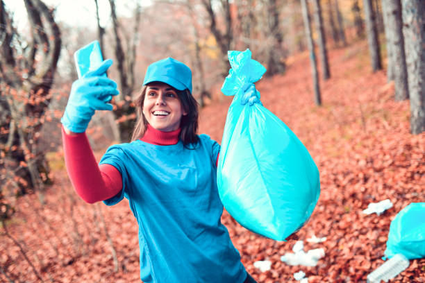Cute Female Volunteer Taking Selfie With Trash Bag