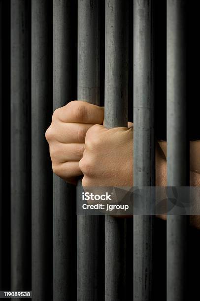 Behind Bars Stock Photo - Download Image Now - Prison Bars, Prison, Rebellion