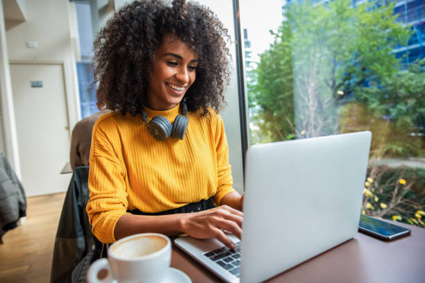 istock Focused young African woman working online in a cafe 1190895537