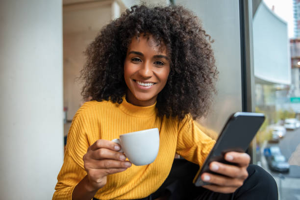 istock Beautiful young woman relaxing at cafe 1190895548