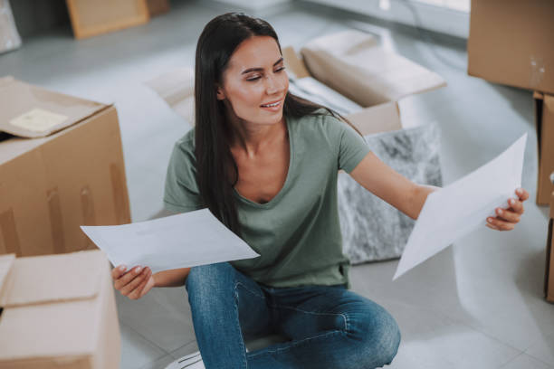 istock Smiling nice woman is looking on sheets of paper 1190902113