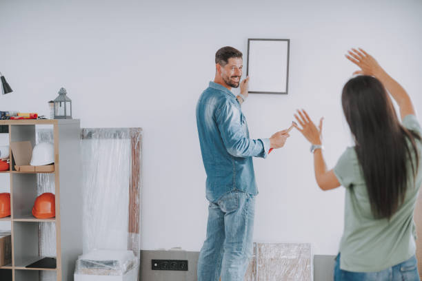 istock Happy man is holding hammer and frame 1190903086