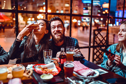 Cute Couple Enjoying Dinner Party With Friends