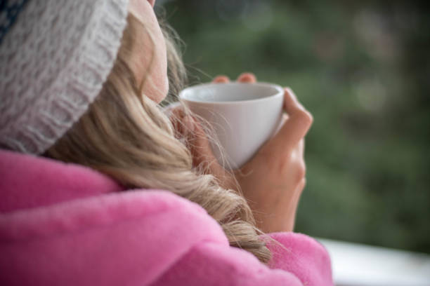 istock Woman holding tea cup 1190904659