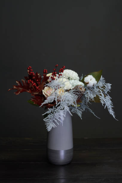 istock Christmas and New Year composition bouquet in a ceramic vase on a dark background, selective focus 1190905641