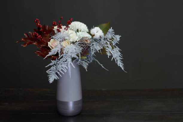 istock Christmas and New Year composition bouquet in a ceramic vase on a dark background, selective focus 1190905933