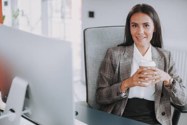 istock Smiling pretty lady with coffee looking at camera 1190906592