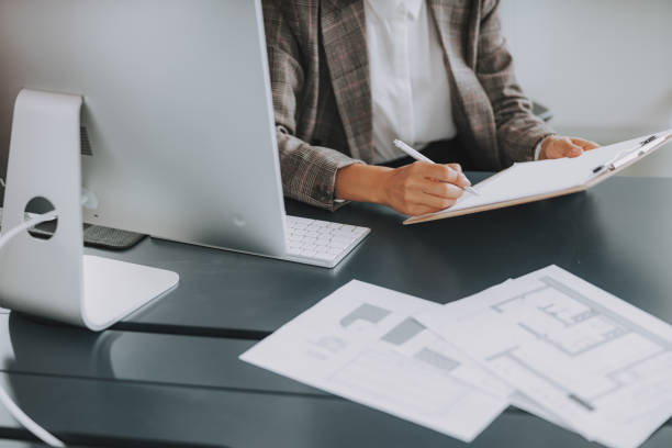 istock Woman is holding pen and document at workplace 1190906627
