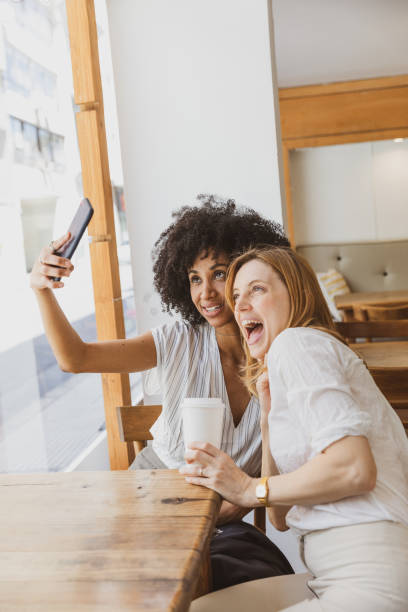 istock Happy selfie with a friend in a cafe 1190909116