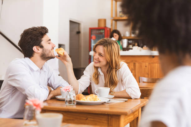 istock Happy breakfast - Couple eating a croissant together 1190909970