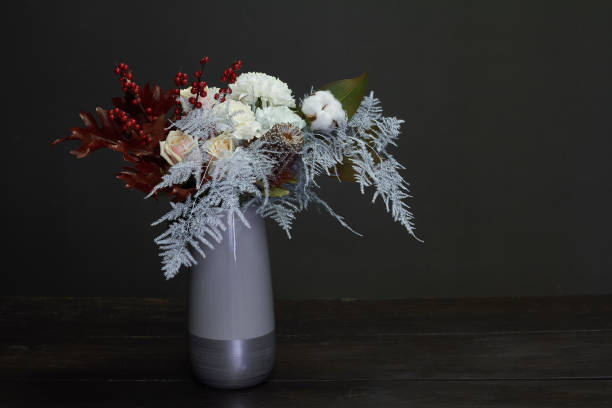 istock Christmas and New Year composition bouquet in a ceramic vase on a dark background, selective focus 1190913508