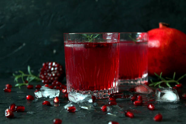 istock Ripe pomegranate with juice on dark background. 1190915627