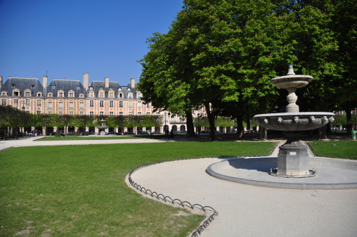 Paris, France - July 11, 2023: Crowd in the Jardin du Luxembourg with the Palais du Luxembourg.