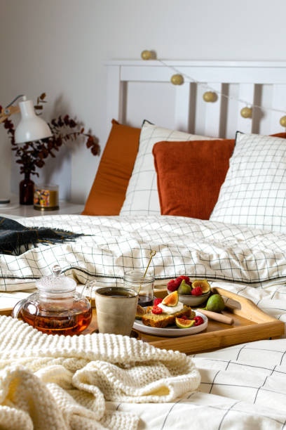 istock Breakfast in bed with pastry and fresh fruits, black tea 1190917507