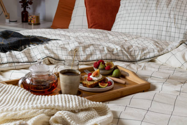 istock Breakfast in bed with pastry and fresh fruits, black tea 1190917558