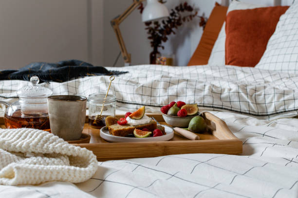 istock Breakfast in bed with pastry and fresh fruits, black tea 1190917607